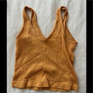 Golden yellow stretch crop tank.